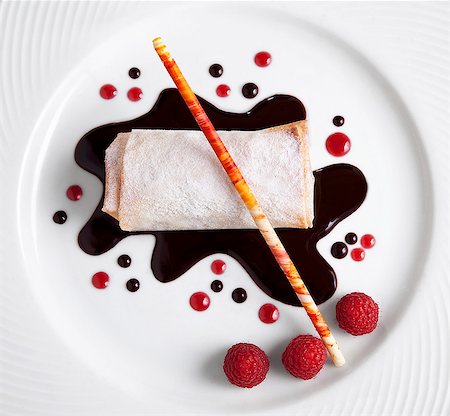 dessert - Rolled Dessert Crepe with Chocolate and Raspberry Sauce, Fresh Raspberries and a Sugar Stick Stock Photo - Premium Royalty-Free, Code: 659-06670860
