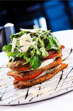 Fried Eggplant Caprese Salad with Arugula and Shaved Parmesan Cheese Stock Photo - Premium Royalty-Free, Code: 659-06670862