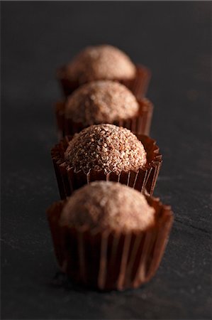 sweet mold - A row of noisette truffle pralines Stock Photo - Premium Royalty-Free, Code: 659-06670961