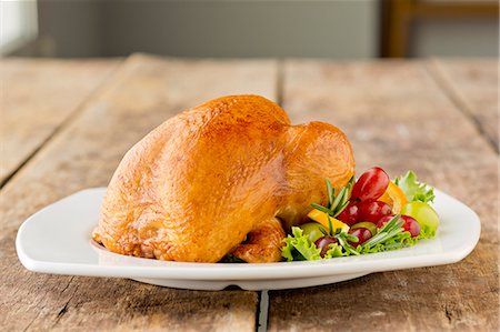 roasted (meat) - Whole Roast Chicken on a White Plate with Grapes Stock Photo - Premium Royalty-Free, Code: 659-06670984