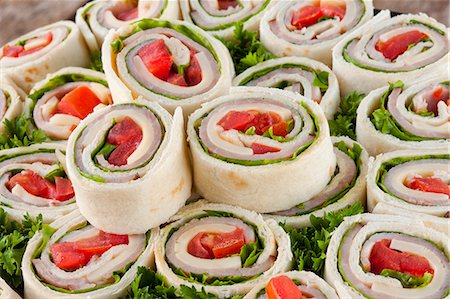sandwiches many - Ham, Cheese, Lettuce and Tomato Wraps; Sliced on a Platter Stock Photo - Premium Royalty-Free, Code: 659-06670985