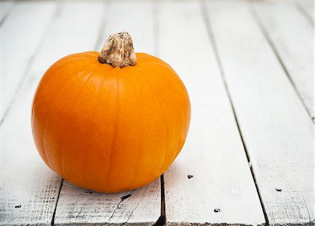 A pumpkin on a wooden table Stock Photo - Premium Royalty-Free, Code: 659-06670994
