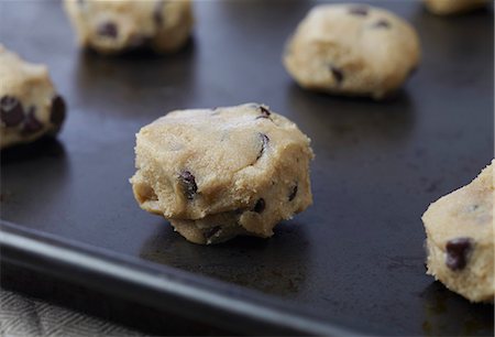 sheet - Unbaked Balls of Chocolate Chip Cookie Dough on a Pan Ready to be Baked Stock Photo - Premium Royalty-Free, Code: 659-06671034
