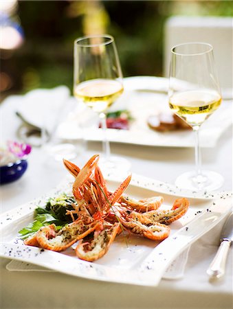 place setting on white - Antipasto di scampi (a starter with langoustine, Italy) Stock Photo - Premium Royalty-Free, Code: 659-06671153