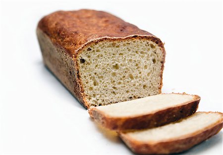 A Loaf of English Muffin Bread with Two Slices Stock Photo - Premium Royalty-Free, Code: 659-06671182