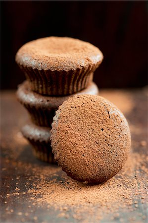 stacked pastries - Chocolate muffins dusted with cocoa powder Stock Photo - Premium Royalty-Free, Code: 659-06671268