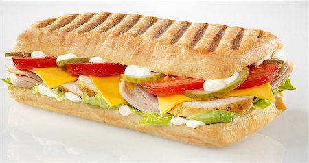 simsearch:659-06155445,k - Chicken, tomato, gherkin, cheese slice and lettuce panini Stock Photo - Premium Royalty-Free, Code: 659-06671358