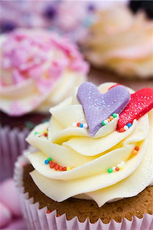 Vanilla cupcakes with hearts and colourful sugar sprinkles Photographie de stock - Premium Libres de Droits, Code: 659-06671389