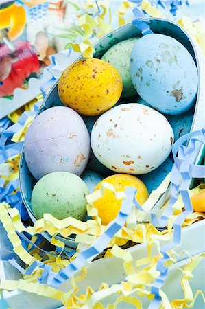 Speckled chocolate eggs in a cardboard Easter egg with streamers Photographie de stock - Premium Libres de Droits, Code: 659-06671392