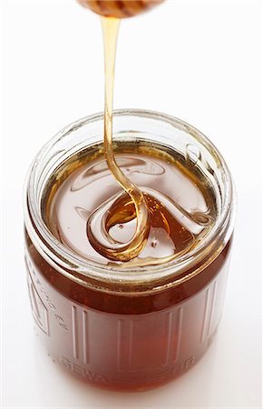 simsearch:659-07599136,k - Honey trickling from a honey dipper into a jar Stock Photo - Premium Royalty-Free, Code: 659-06671524