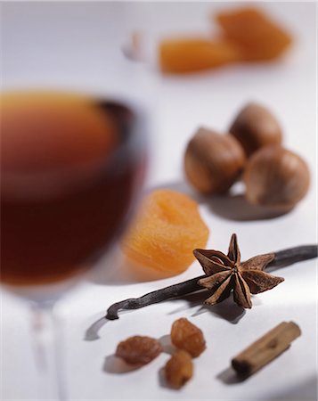 simsearch:659-06307451,k - A glass of dessert wine, spices, nuts and dried fruits Photographie de stock - Premium Libres de Droits, Code: 659-06671652