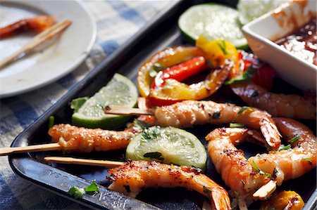 Grilled Shrimp with Toothpicks on a Baking Pan with Lime and Cocktail Sauce Stock Photo - Premium Royalty-Free, Code: 659-06671662