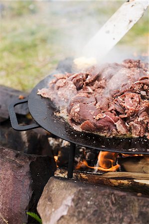 Reindeer meat being grilled on a bonfire (Scandinavia) Stock Photo - Premium Royalty-Free, Code: 659-06671692