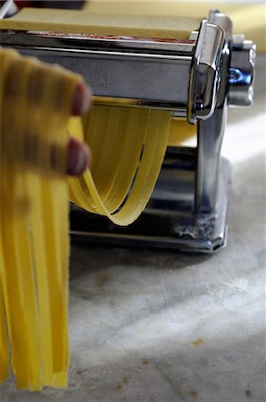 pasta maker - Tagliatelle being cut with a pasta machine Stock Photo - Premium Royalty-Free, Code: 659-06900777