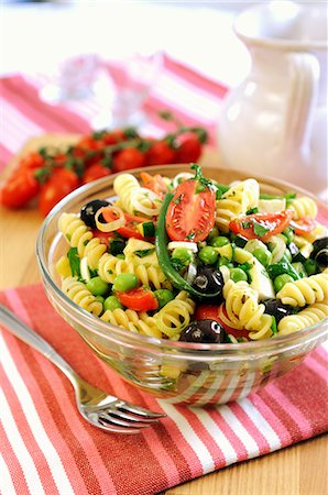 simsearch:659-07027538,k - A bowl of pasta salad with green beans, peas, tomatoes, olives and spring onions Stock Photo - Premium Royalty-Free, Code: 659-06900878