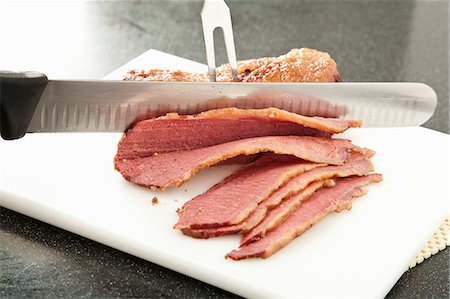 simsearch:659-06901276,k - Slicing Corned Beef on a White Plastic Cutting Board Stock Photo - Premium Royalty-Free, Code: 659-06901278