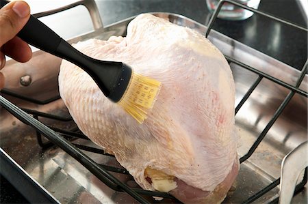 fat (food substance) - Brushing Butter on a Turkey Breast in the Oven for Roasting Stock Photo - Premium Royalty-Free, Code: 659-06901281
