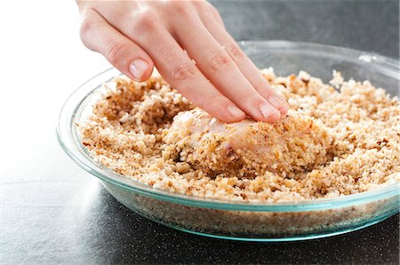 Coating Chicken in Bread Crumbs to Make Crunchy Baked Chicken Stock Photo - Premium Royalty-Free, Code: 659-06901300