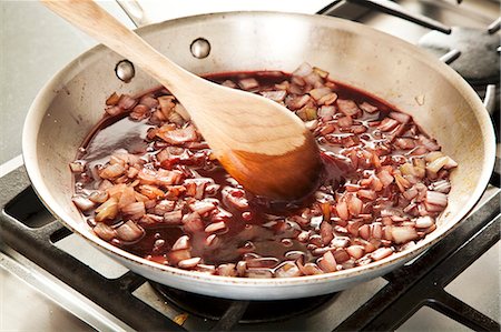 simsearch:659-07739305,k - Stirring Wine into Sauteed Onions to Add to Beef Stew Stock Photo - Premium Royalty-Free, Code: 659-06901324