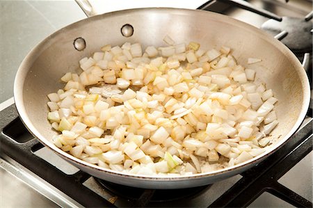 frying pan - Sauteing Onions in a Skillet Stock Photo - Premium Royalty-Free, Code: 659-06901326