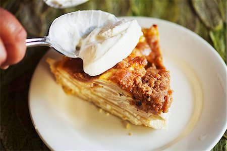 fruit cake with cream - Spooning Whipped Cream onto a Slice of Sour Cream Apple Pie Stock Photo - Premium Royalty-Free, Code: 659-06901478