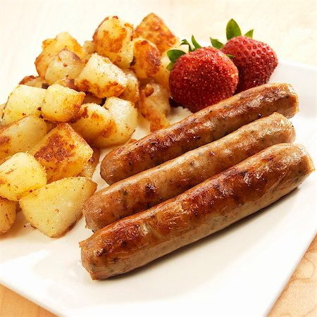 sausage recipe - Three Breakfast Sausages with Homefries and Strawberries Stock Photo - Premium Royalty-Free, Code: 659-06901540