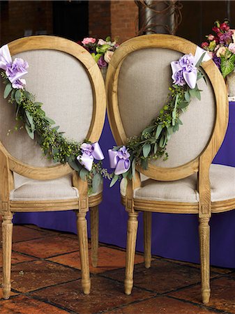 flower decoration - Chairs Decorated with Fresh Garland and Ribbon for the Bride and Groom at a Wedding Reception Stock Photo - Premium Royalty-Free, Code: 659-06901599