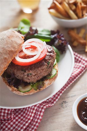 simsearch:659-07027045,k - A home-made hamburger with cucumber, tomato and lettuce Stock Photo - Premium Royalty-Free, Code: 659-06901794