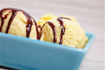 A few scoops of home-made vanilla ice cream with chocolate sauce in a bowl Photographie de stock - Premium Libres de Droits, Code: 659-06901874