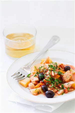 Pot-roasted cod with potatoes, olives and pine nuts Stock Photo - Premium Royalty-Free, Code: 659-06901997