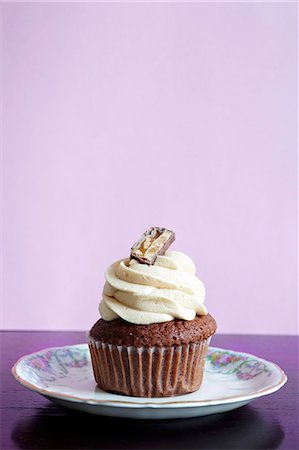 simsearch:659-06493804,k - A chocolate cupcake topped with cream Stock Photo - Premium Royalty-Free, Code: 659-06902116