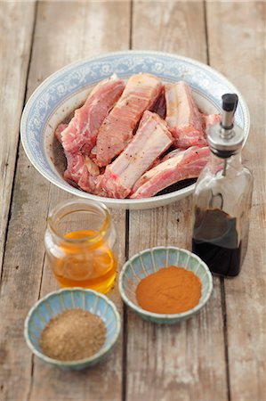 Pork ribs with ingredients for the marinade (honey, soy sauce, spices) Stock Photo - Premium Royalty-Free, Code: 659-06902465