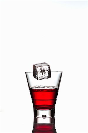 simsearch:659-06902475,k - Ice cube falling into a glass of Campari Stock Photo - Premium Royalty-Free, Code: 659-06902471