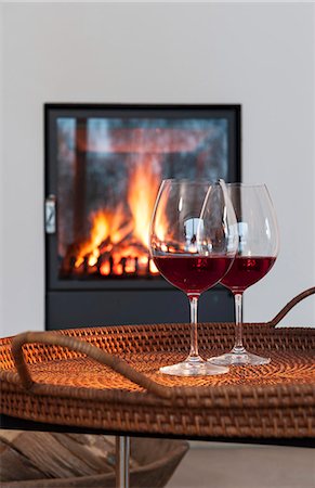 salver - Two glasses of red wine on a table in front of a fireplace Stock Photo - Premium Royalty-Free, Code: 659-06902473