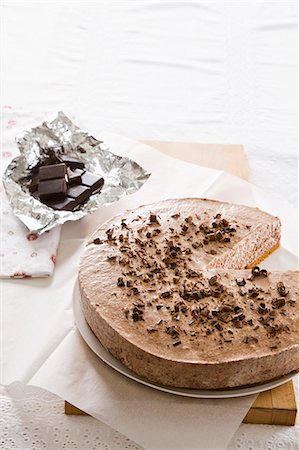 simsearch:659-06372527,k - Chocolate mousse cake being cut Stock Photo - Premium Royalty-Free, Code: 659-06902973