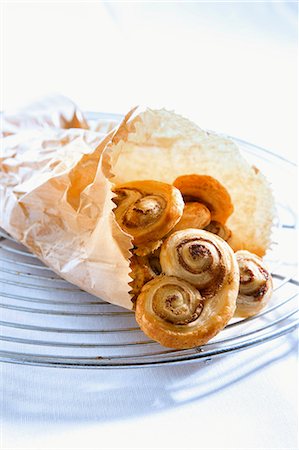 danish pastry recipe - Puff pastry 'pig's ears' in a paper bag Stock Photo - Premium Royalty-Free, Code: 659-06903002