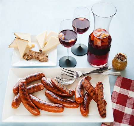 Platter of Grilled Sausages, Cheese Plate and Glasses and Pitcher of Sangria Stock Photo - Premium Royalty-Free, Code: 659-06903057