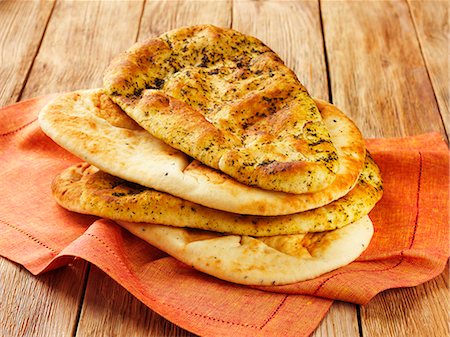 south asian cooking - Naan breads with and without herbs Stock Photo - Premium Royalty-Free, Code: 659-06903097