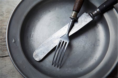 food in the plate - A tin plate with silver cutlery Stock Photo - Premium Royalty-Free, Code: 659-06903252