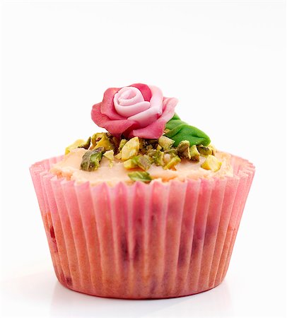 simsearch:659-06495442,k - A celebration cupcake decorated with pistachios and a marzipan rose Stock Photo - Premium Royalty-Free, Code: 659-06903318