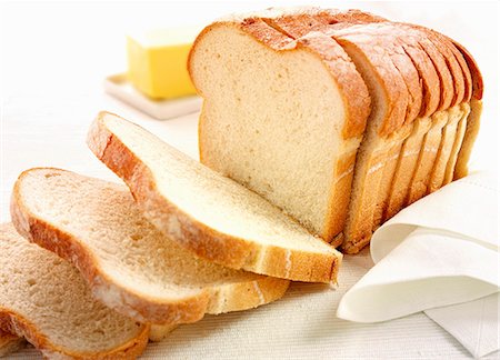fat (food substance) - Sliced bread with a pat of butter Stock Photo - Premium Royalty-Free, Code: 659-06903380