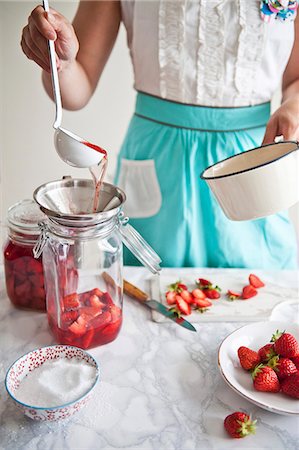 sweet lady cooking - Strawberry compote being spooned into a preserving jar Stock Photo - Premium Royalty-Free, Code: 659-06903414