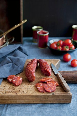 Cured sausage with paprika, on a chopping board Stock Photo - Premium Royalty-Free, Code: 659-06903410