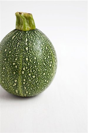 Single spherical courgette against white Stock Photo - Premium Royalty-Free, Code: 659-06903525