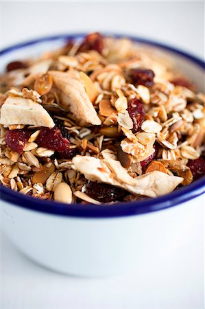 simsearch:659-07610054,k - Museli made with rolled oats, dried cranberries, dried apple, desicated coconut and sunflower seeds. Stock Photo - Premium Royalty-Free, Code: 659-06903531