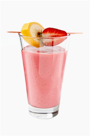 fruit skewers for cocktails - A strawberry smoothie with banana and strawberry pieces on a cocktail stick Stock Photo - Premium Royalty-Free, Code: 659-06903552