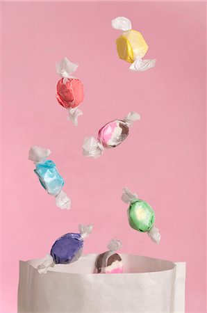 sweets candy - Sweets falling into a paper bag Stock Photo - Premium Royalty-Free, Code: 659-06903642