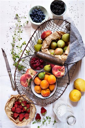 fruit and white background - A still life of a wire basket with fresh summer fruits Photographie de stock - Premium Libres de Droits, Code: 659-06903783