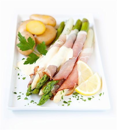 simsearch:659-01848408,k - Asparagus wrapped in ham with Hollandaise sauce and potatoes Stock Photo - Premium Royalty-Free, Code: 659-06903928