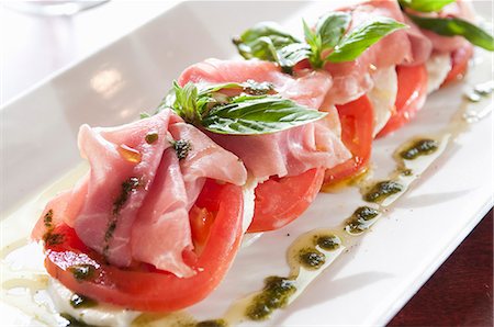 simsearch:659-06187367,k - Caprese Salad with Prosciutto and Herb Sauce Stock Photo - Premium Royalty-Free, Code: 659-07026779